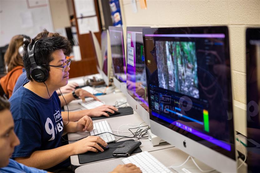 A student edits at a computer